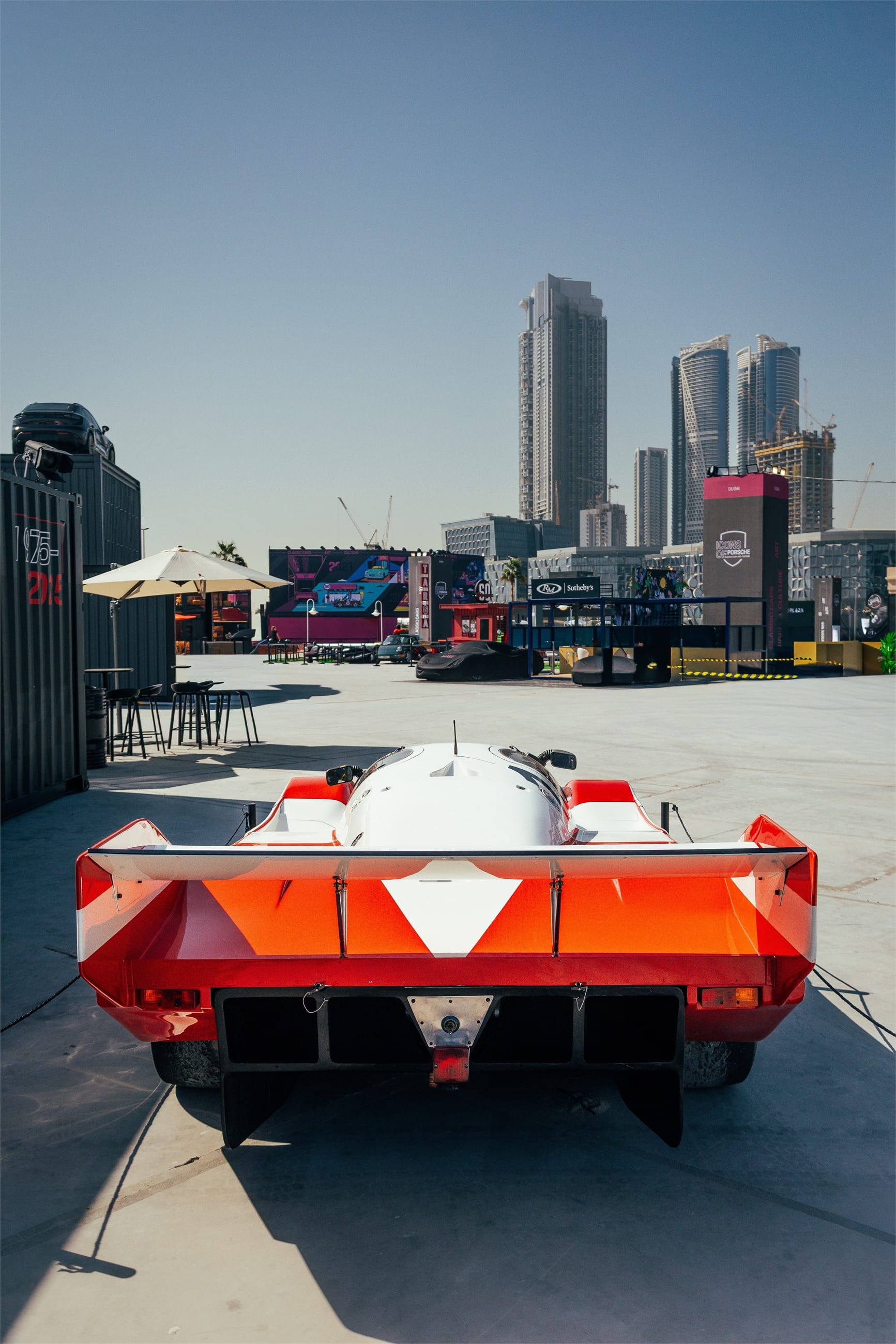 Rear of the Le Mans racer, the city skyline beyond.