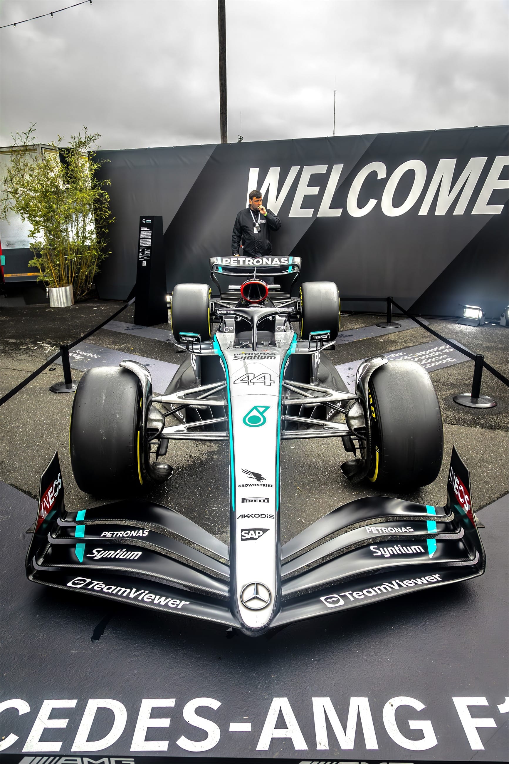 A Formula One car displayed under a welcome banner.